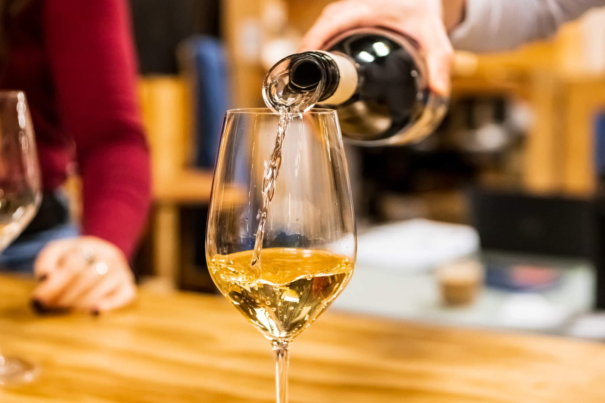 Man holding a wine glass with rose for a wine tasting.